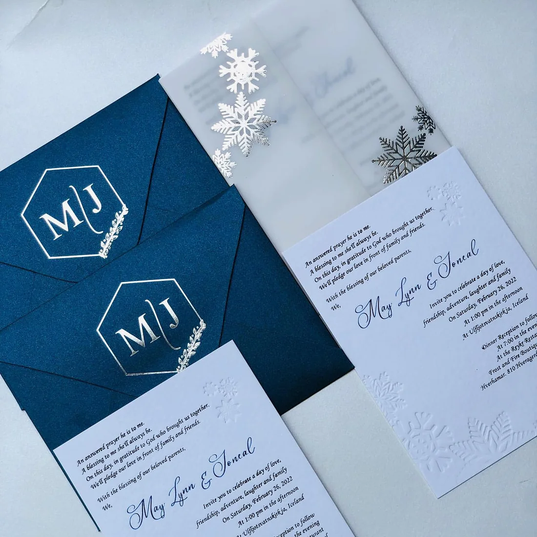 Navy envelope with a foil hexagon monogram and vellum overlay